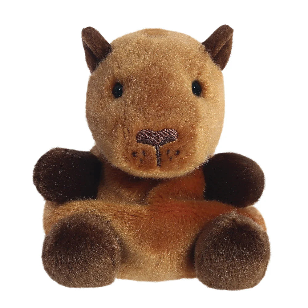 Aurora Palm Pals Sid Capybara plush — a tan and dark brown capybara soft toy with a broad flat muzzle, small dark ears, embroidered nose detail, and a relaxed seated pose