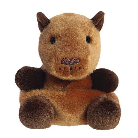 Aurora Palm Pals Sid Capybara plush — a tan and dark brown capybara soft toy with a broad flat muzzle, small dark ears, embroidered nose detail, and a relaxed seated pose