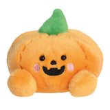 Plush pumpkin toy with a smiling face on a white background