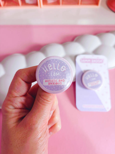 Peachy Lane Studio Hello I Am Autistic and Anxious badge held, lilac, 38mm pin badge