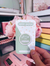 Peachy Lane Studio Hello I Am Autistic 38mm badge, sage green, with floral background
