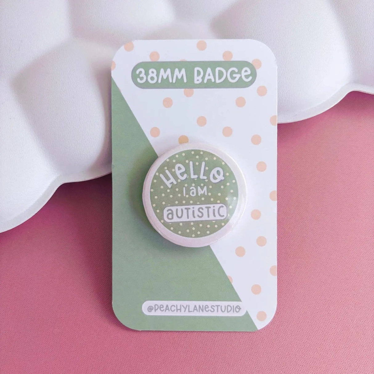 Peachy Lane Studio Hello I Am Autistic badge, sage green, on pink background