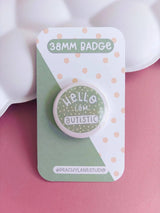 Peachy Lane Studio Hello I Am Autistic 38mm badge, sage green, clean pink background