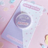 Peachy Lane Studio Hello I Am Autistic badge, lilac, angled on backing card