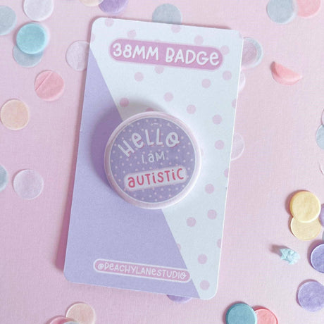 Peachy Lane Studio Hello I Am Autistic 38mm badge, lilac, with confetti background