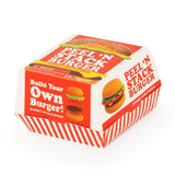 Keycraft Peel N Stack Burger sensory toy in red and white striped burger box packaging, angled view