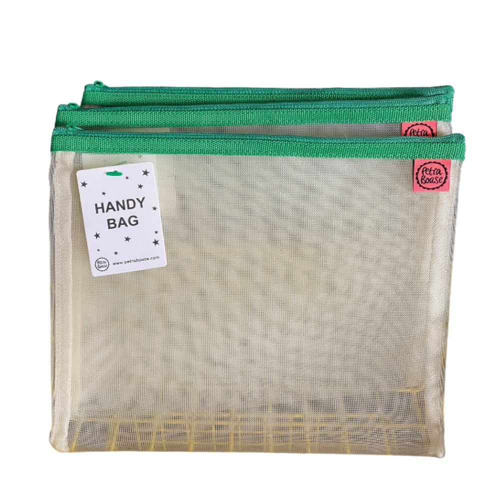 Two Petra Boase pale mesh handy bags with green zip stacked together showing Handy Bag tag, front view