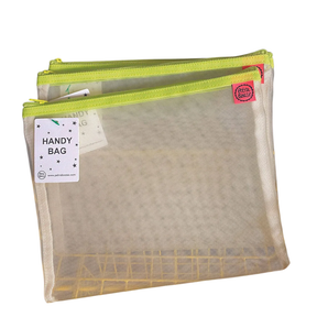 Petra Boase pale mesh handy bag with lime yellow zip shown against white background with Handy Bag tag