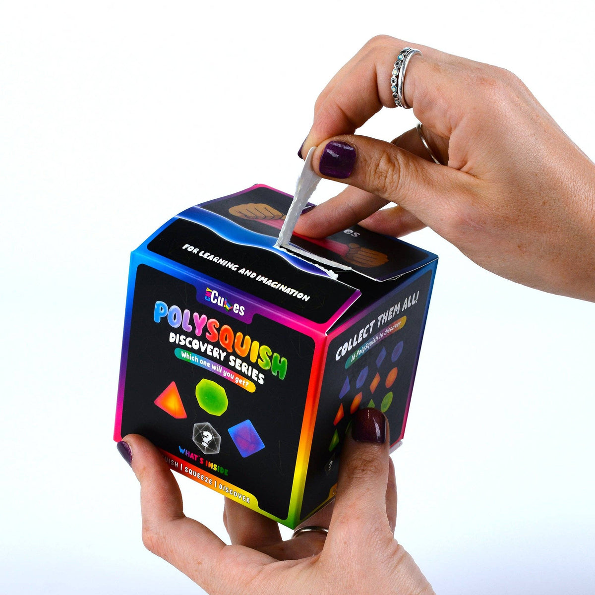 Person opening a Polysquish discovery series box with colorful packaging.