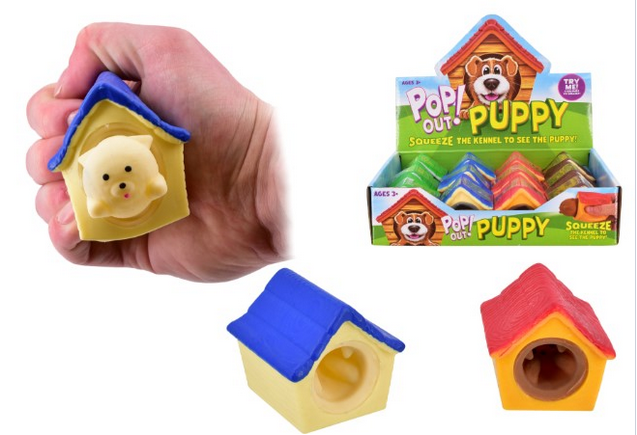 Hand squeezing a yellow and blue Pop Out Puppy kennel toy causing a puppy face to appear, with both colour variants and retail display box shown