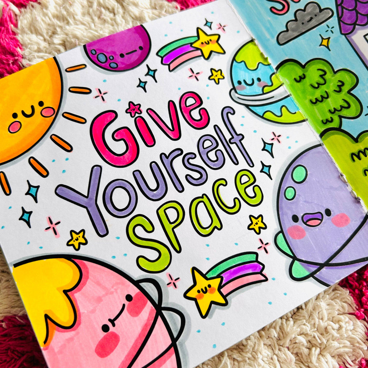 Completed colouring page reading Give Yourself Space surrounded by kawaii planet and space characters