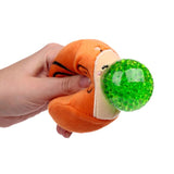 Hand squeezing an orange plush snail Queasy Squeezie causing green water bead nose to bulge out