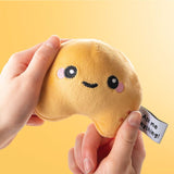 Queasy Squeezies fortune teller cookie sensory plush held in hands, yellow background