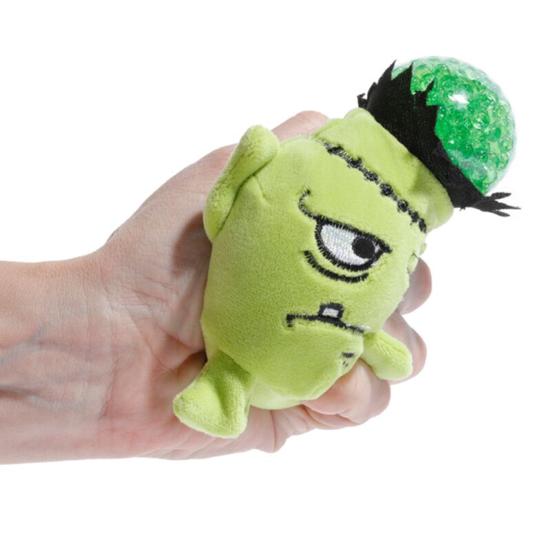 Hand squeezing the green gel bead centre of a Queasy Squeezies Frankenstein plush toy