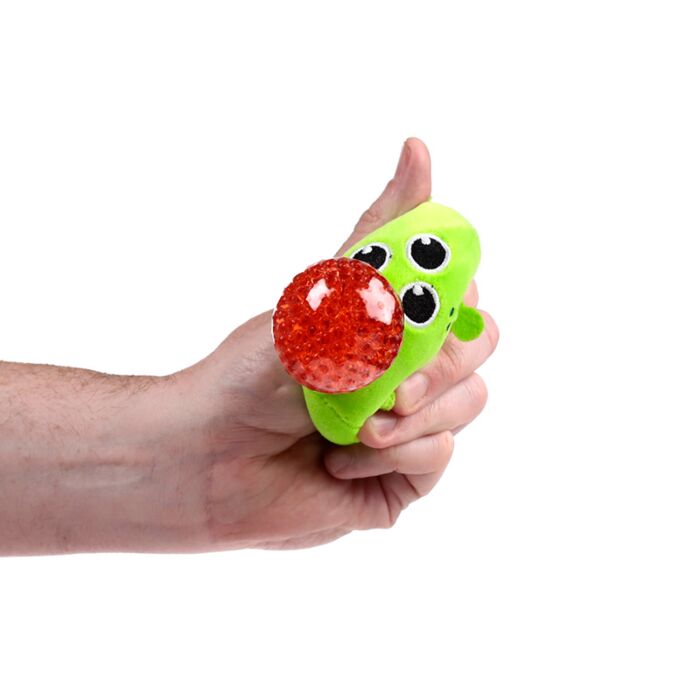 Hand squeezing a green three-eyed alien Queasy Squeezie causing a red water bead nose to bulge out