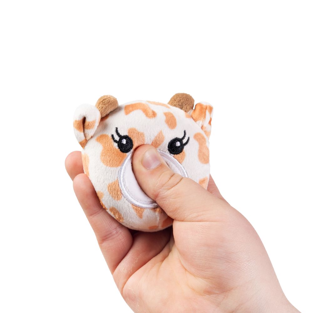 Hand squeezing a kawaii giraffe plush sensory toy showing soft sugar-filled compression