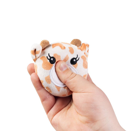 Hand squeezing a kawaii giraffe plush sensory toy showing soft sugar-filled compression