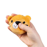 Hand squeezing a kawaii tiger plush sensory toy showing soft sugar-filled compression and embroidered muzzle detail