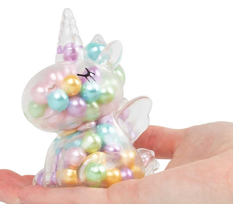 Scrunchems ASMR Rainbow Unicorn bead-filled squishy unicorn resting in open hand showing size and detail.