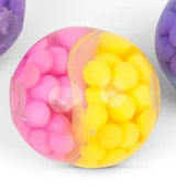 Close-up of a pink and yellow bead-filled Scrunchems ASMR squish ball