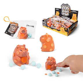 Scrunchems Sticky Squishy Capybara shown with resealable bag packaging, sticky blue balls, and retail display box