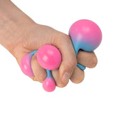 Hand squeezing Scrunchems Colour Change Squish Ball as it shifts from pink to blue