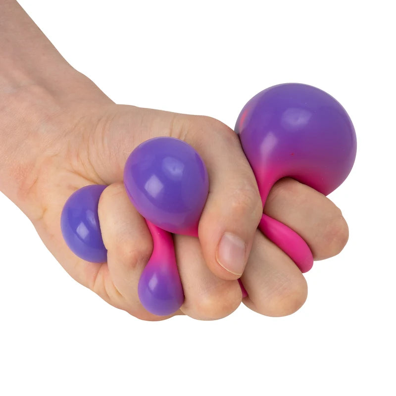 Hand squeezing Scrunchems Colour Change Squish Ball as it shifts from purple to pink