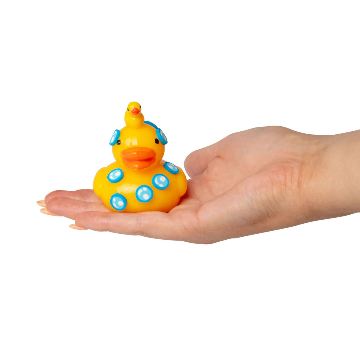Yellow Scrunchems Sticky Squishy Duck with mini duckling on top and blue bubble details resting on an open palm