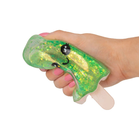 Hand squeezing and deforming a green glitter Scrunchems Sugar Ice Lolly squishy