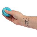 Hand squeezing a teal blue mini kawaii dumpling squishy toy from the Mega Rainbow set