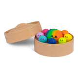 Angled view of an open Scrunchems steamer box filled with nine kawaii dumpling squishy toys