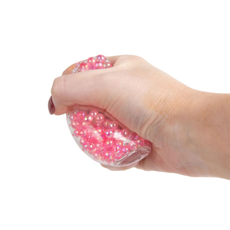 Pink Scrunchems Mini ASMR Crunch Cube squeezed in hand, bead sensory fidget toy