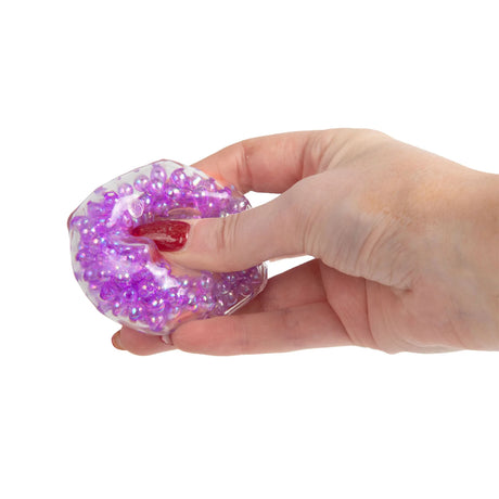 Purple Scrunchems Mini ASMR Crunch Cube squeezed in hand, bead sensory fidget toy