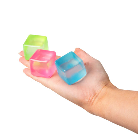 Pink, blue and green Scrunchems Mini Sugar Cubes squishy sensory toys resting in a palm