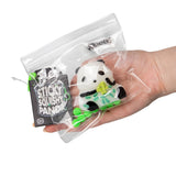Scrunchems Sticky Squishy Panda in sealed bag with branded tag and green clip hanger resting on an open palm