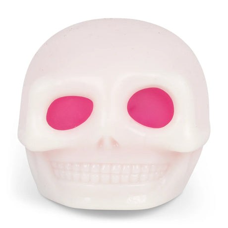 Pale glow-in-the-dark skull squishy with hot pink eye sockets, displayed front-on