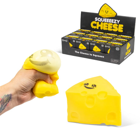 Hand squeezing Squeezezy Cheese squishy alongside product and retail display box