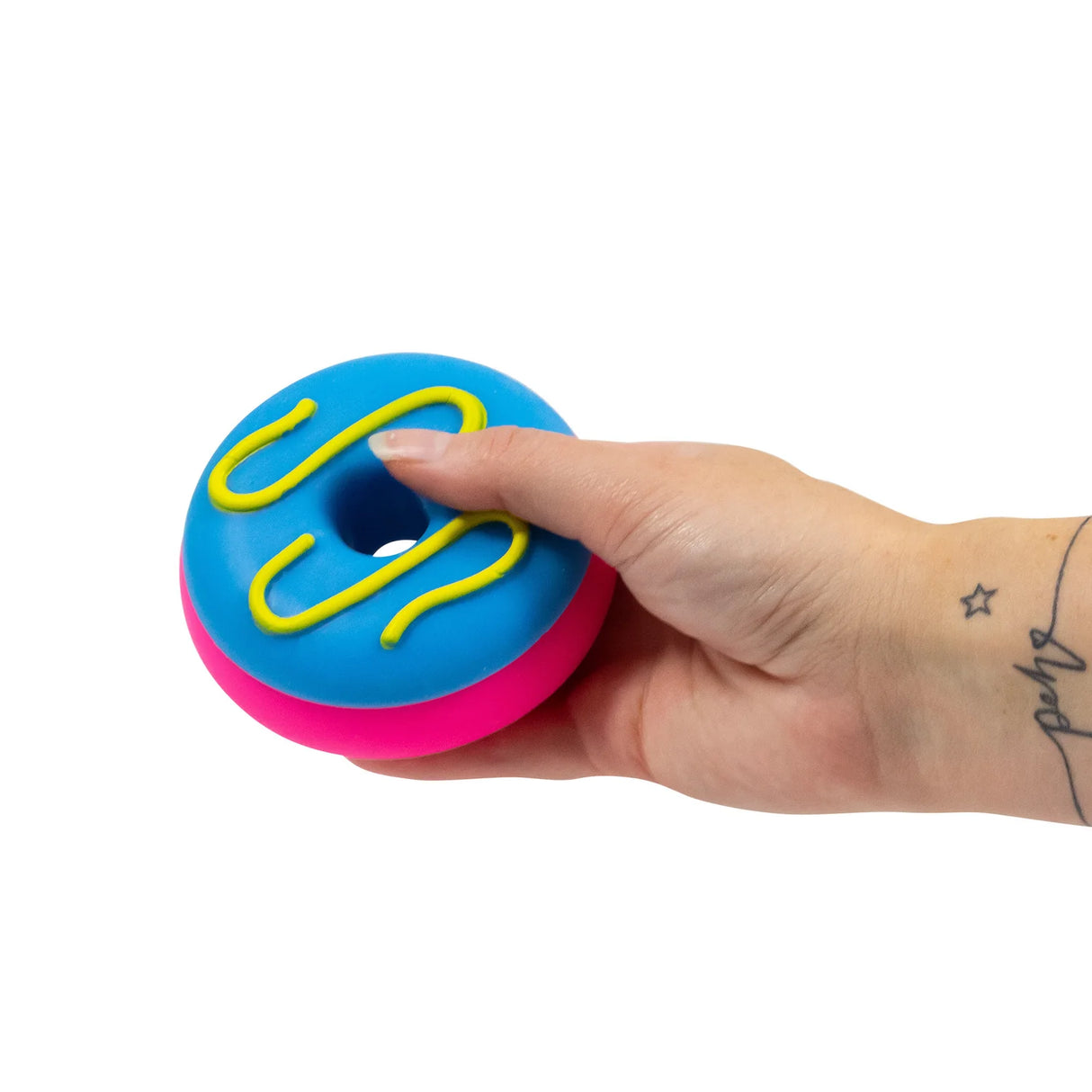 Hand holding a blue and pink squishy donut fidget toy with yellow icing swirl detail