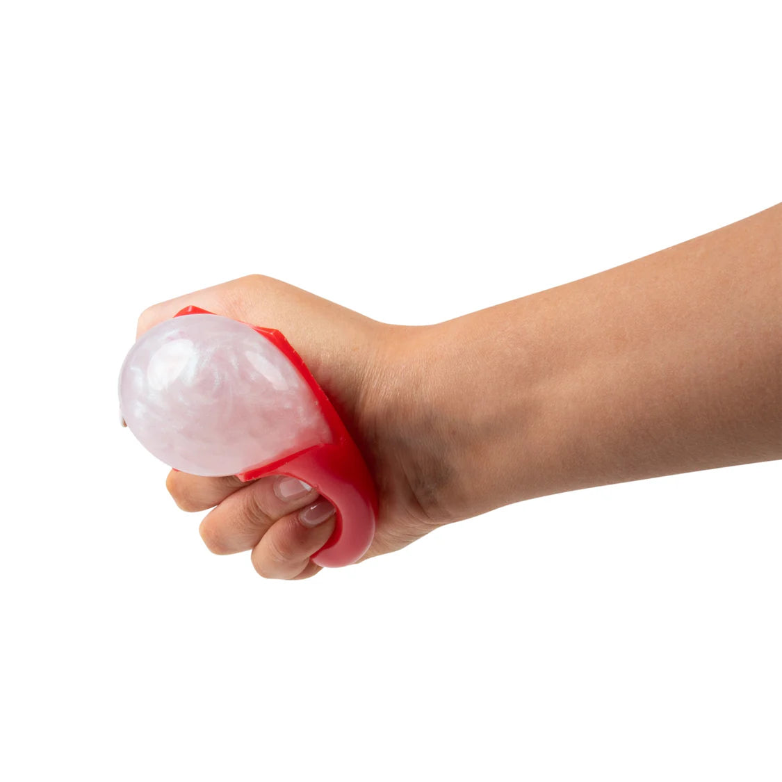 Adult hand squeezing the red squishy eyeball from the side, showing the pearlescent white eyeball protruding