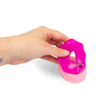 Hand lifting magenta sticky icing layer off pink Scrunchems Sticky Squishy Donut base