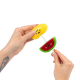 Hands sliding mango and watermelon sticky squishies onto Scrunchems Fruit Stack straw