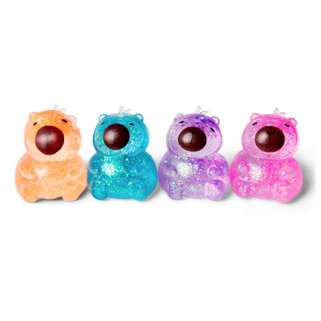 All four Scrunchems Sugar Capybara glitter squishies in orange, blue, purple and pink lined up in a row