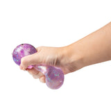 Hand squeezing and deforming a purple holographic glitter Scrunchems Sugar Capybara squishy