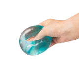Blue and white marbled Scrunchems Sugar Cube being gripped in a hand