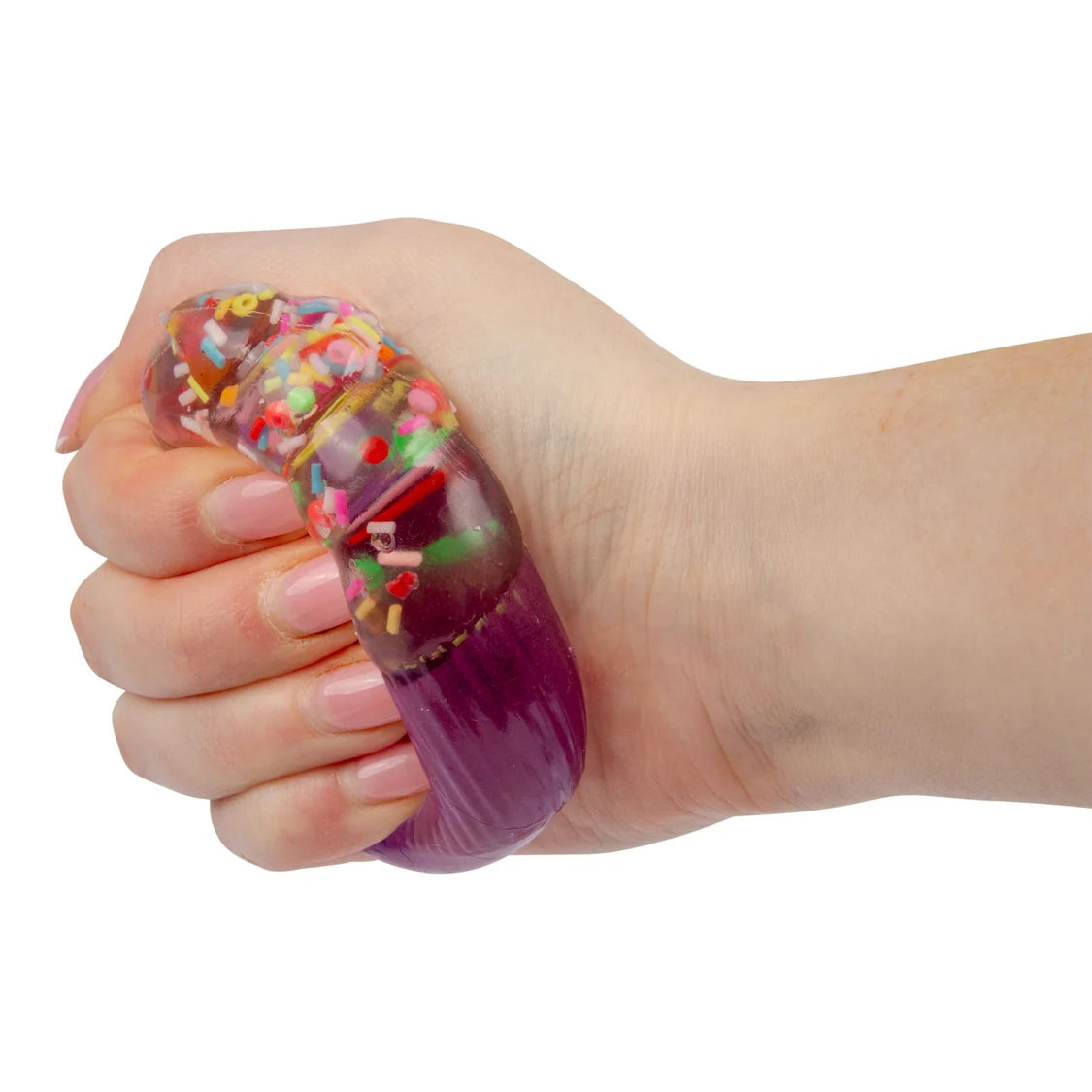 Hand squeezing a purple Scrunchems Sugar Cupcake toy showing the gel and sprinkle filling