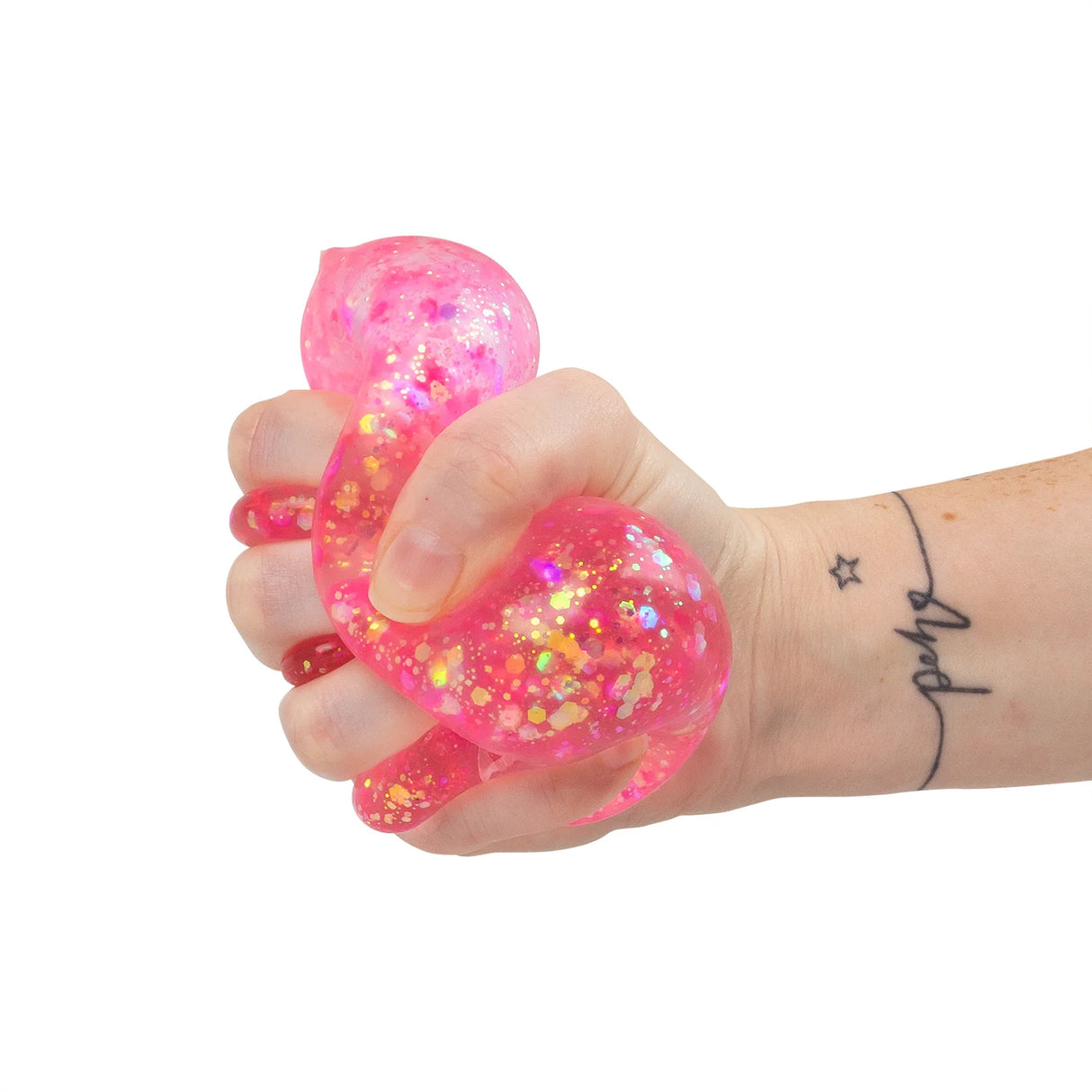 Hand squeezing a pink holographic glitter Scrunchems Sugar Diamond squishy, deforming its shape