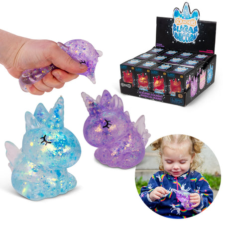Blue and purple glitter Scrunchems Sugar Unicorn squishies shown with hand squeezing one and retail display box