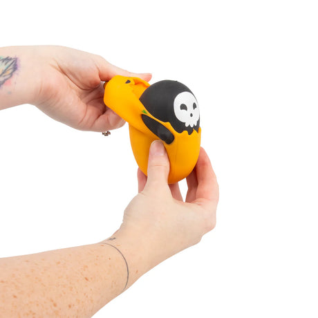Scrunchems Switch N Squeeze Ghost orange pumpkin costume being pulled apart in hands