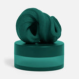 Forest green silicone focus putty swirled on top of matching frosted storage jar