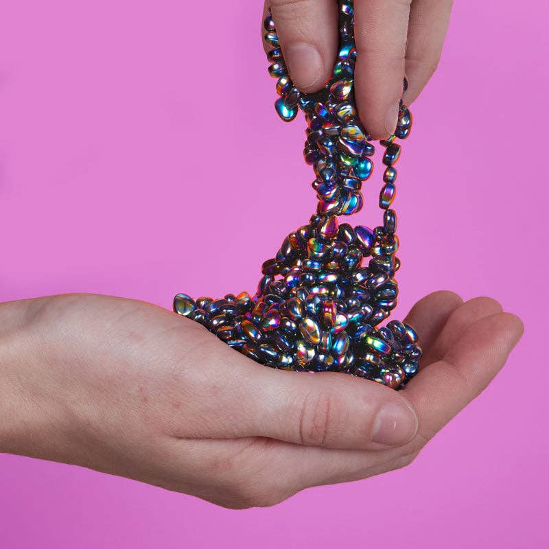Speks Crags Oil Slick iridescent magnetic fidget putty being poured into hand